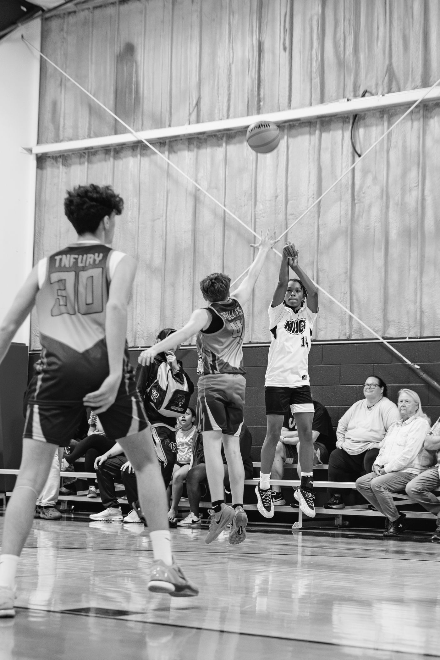 Kings player contesting a shot at the rim in black and white.