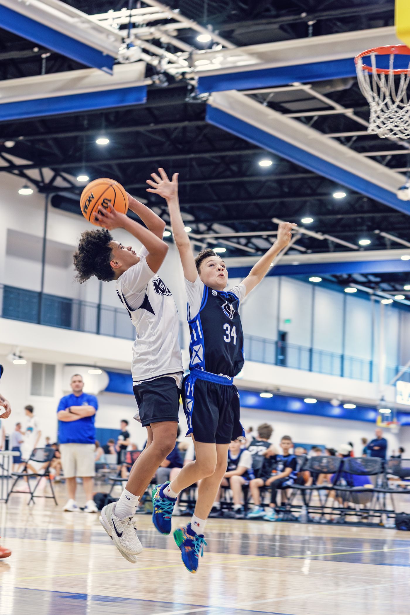 Kings player shooting over a defender near the basket.